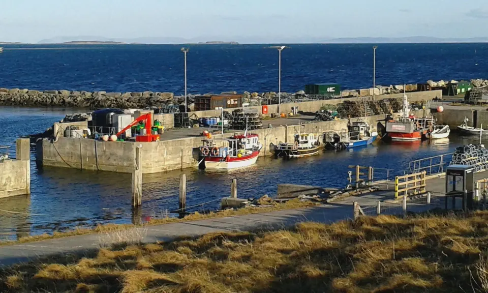 Fishing boats moored inside the stone harbour walls